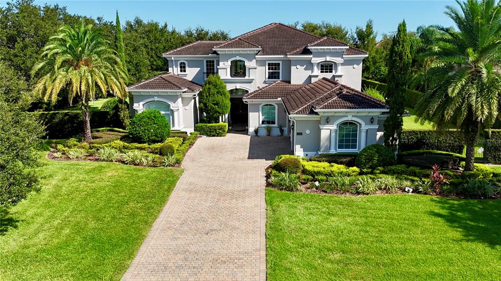 13448 Bellaria Circle Windermere, FL 34786 - Photo 56 of 66 a front view of a house with a garden