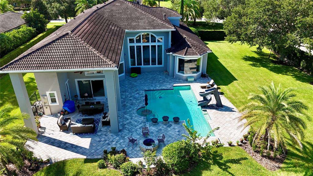 13448 Bellaria Circle Windermere, FL 34786 - Photo 57 of 65 a aerial view of a house with table and chairs under an umbrella