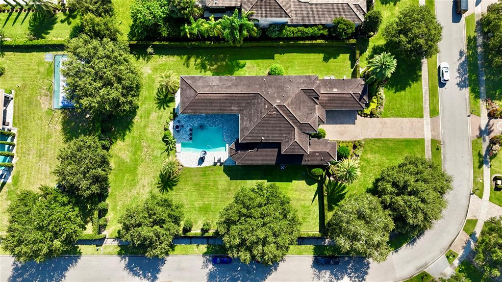 13448 Bellaria Circle Windermere, FL 34786 - Photo 60 of 65 an aerial view of a house with garden space and a lake view