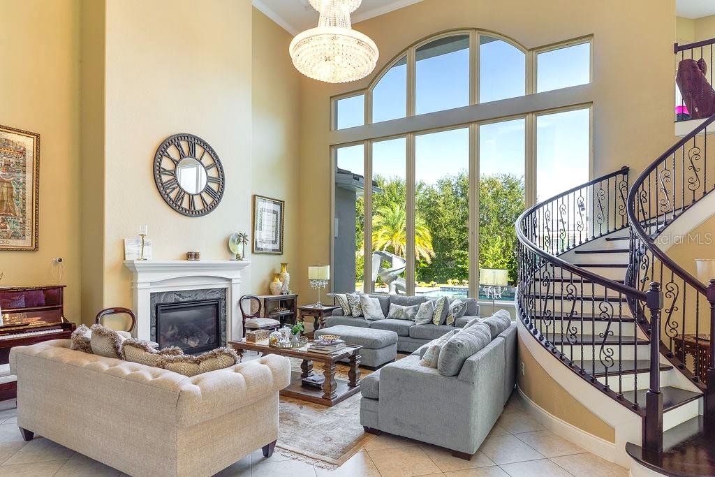 13448 Bellaria Circle Windermere, FL 34786 - Photo 6 of 66 a living room with furniture a fireplace and a large window