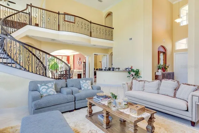 a living room with furniture a rug and a window
