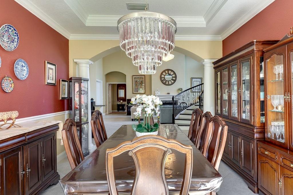 13448 Bellaria Circle Windermere, FL 34786 - Photo 8 of 66 a view of a dining room with furniture chandelier and wooden floor