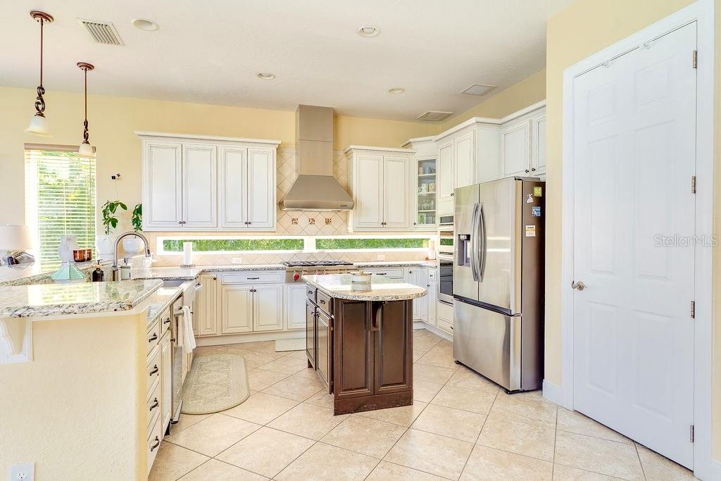 13448 Bellaria Circle Windermere, FL 34786 - Photo 10 of 66 a kitchen with kitchen island granite countertop appliances cabinets and a sink