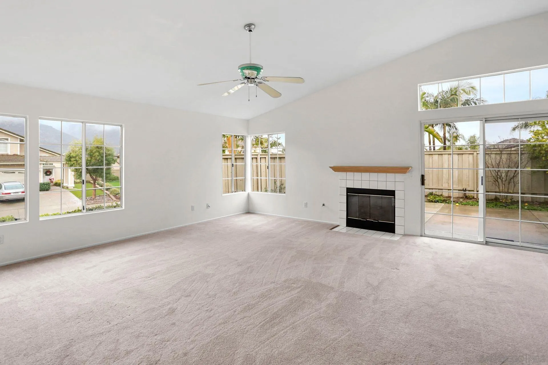 8472 Mesa Heights Road Santee, CA 92071 - Photo 12 of 34 an empty room with windows and fireplace