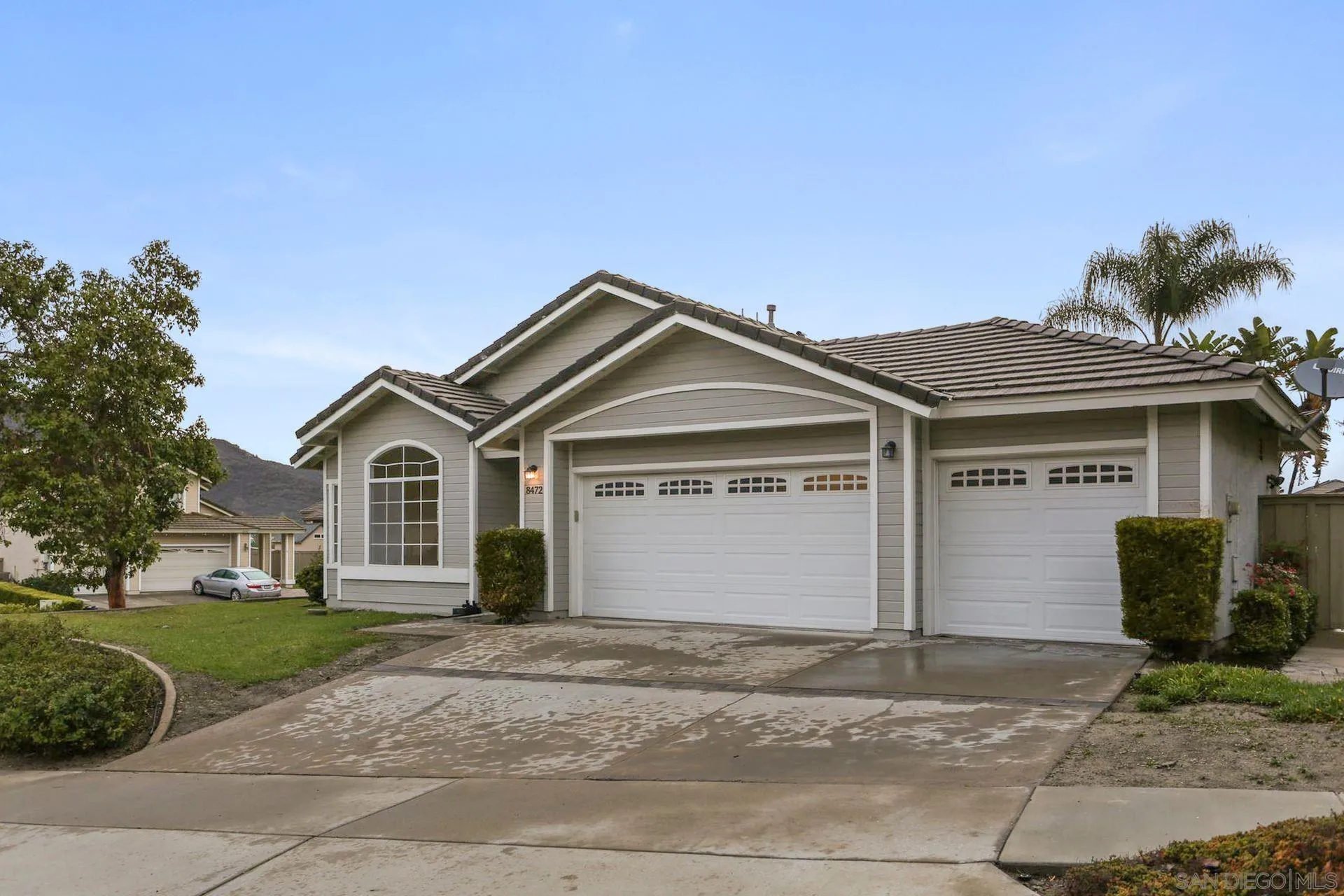 8472 Mesa Heights Road Santee, CA 92071 - Photo 2 of 34 a front view of a house with a yard and garage
