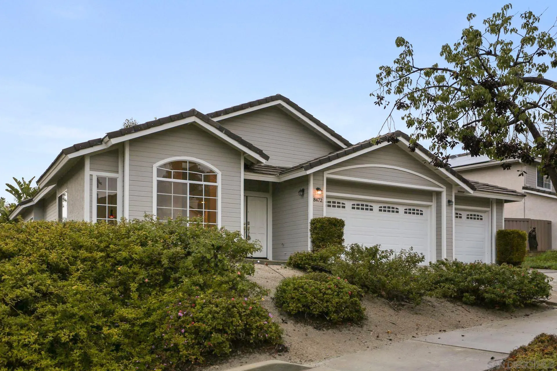 8472 Mesa Heights Road Santee, CA 92071 - Photo 3 of 34 a front view of a house with garden