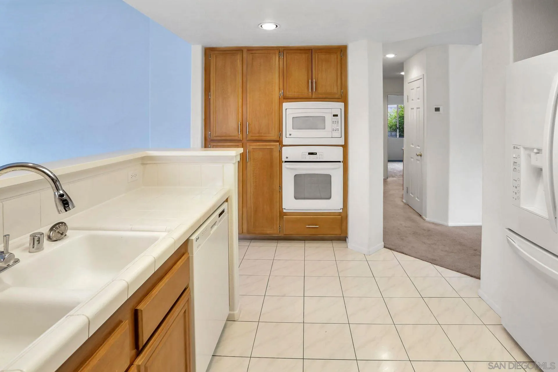 8472 Mesa Heights Road Santee, CA 92071 - Photo 5 of 34 a kitchen with a sink and a refrigerator