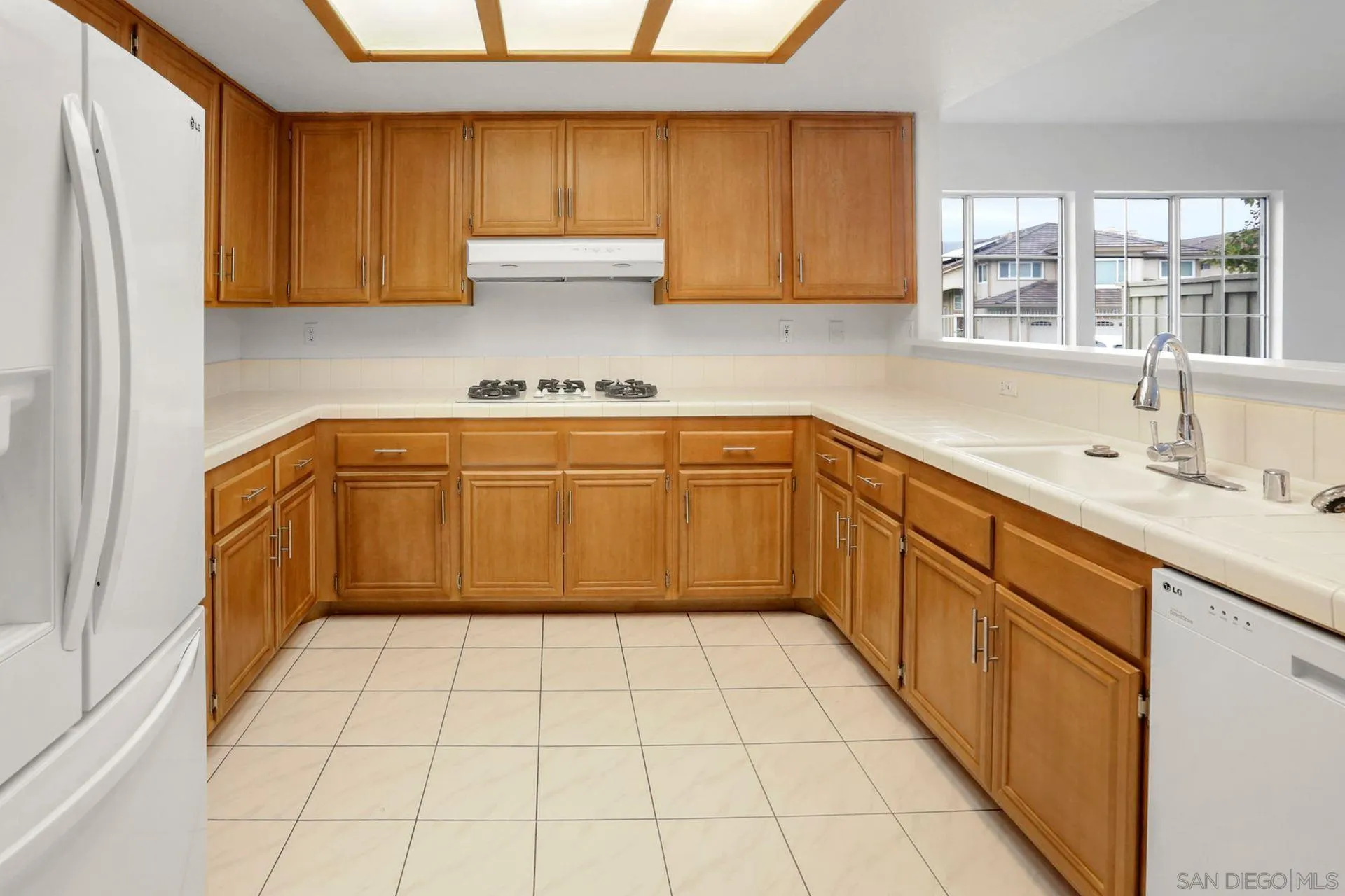 8472 Mesa Heights Road Santee, CA 92071 - Photo 6 of 34 a kitchen with a sink a stove top oven cabinets and a window
