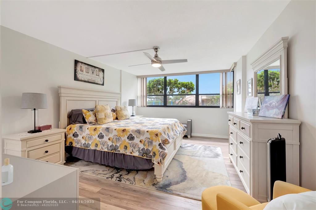 899 Jeffery Street, Unit 109 Boca Raton, FL 33487 - Photo 14 of 37 a bedroom with a large bed and a fireplace