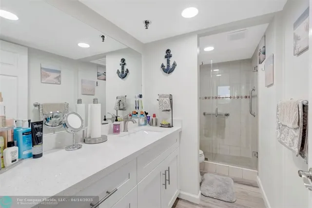 a bathroom with double vanity and a shower