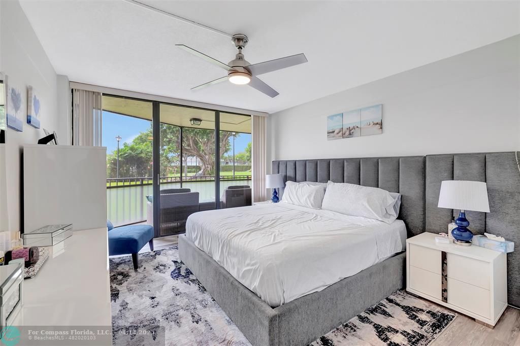 899 Jeffery Street, Unit 109 Boca Raton, FL 33487 - Photo 18 of 37 a bedroom with a large bed and a window