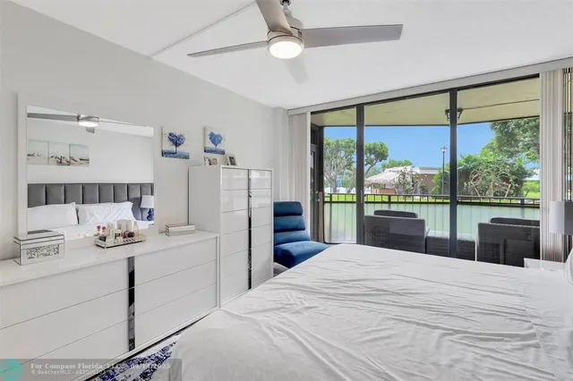 a bedroom with a large bed and a large window