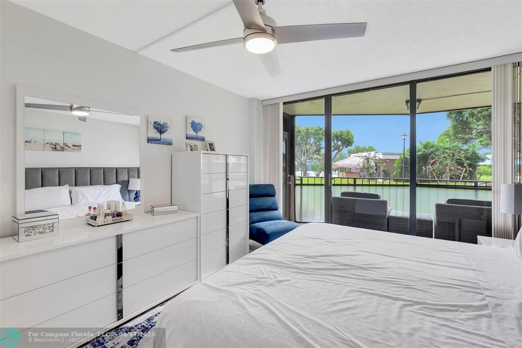 899 Jeffery Street, Unit 109 Boca Raton, FL 33487 - Photo 19 of 37 a bedroom with a large bed and a large window