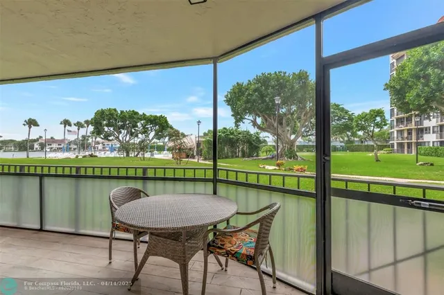 a view of a balcony with lake view and a table