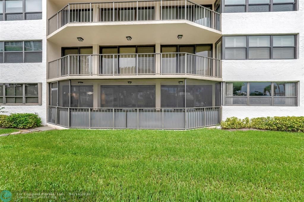 899 Jeffery Street, Unit 109 Boca Raton, FL 33487 - Photo 26 of 37 a front view of a house with a yard