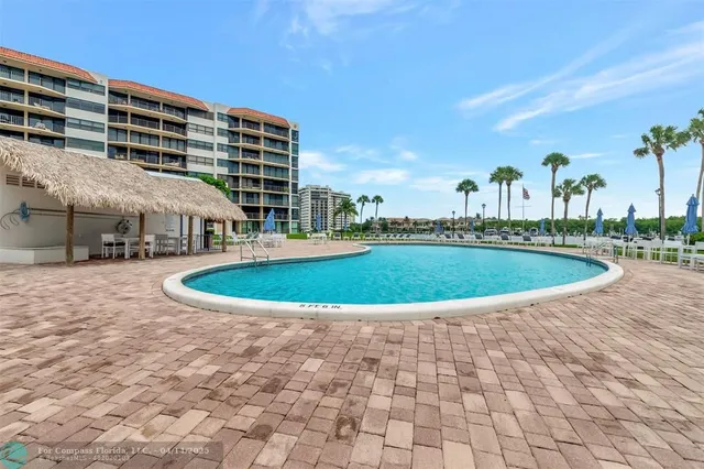 a view of a swimming pool with a yard