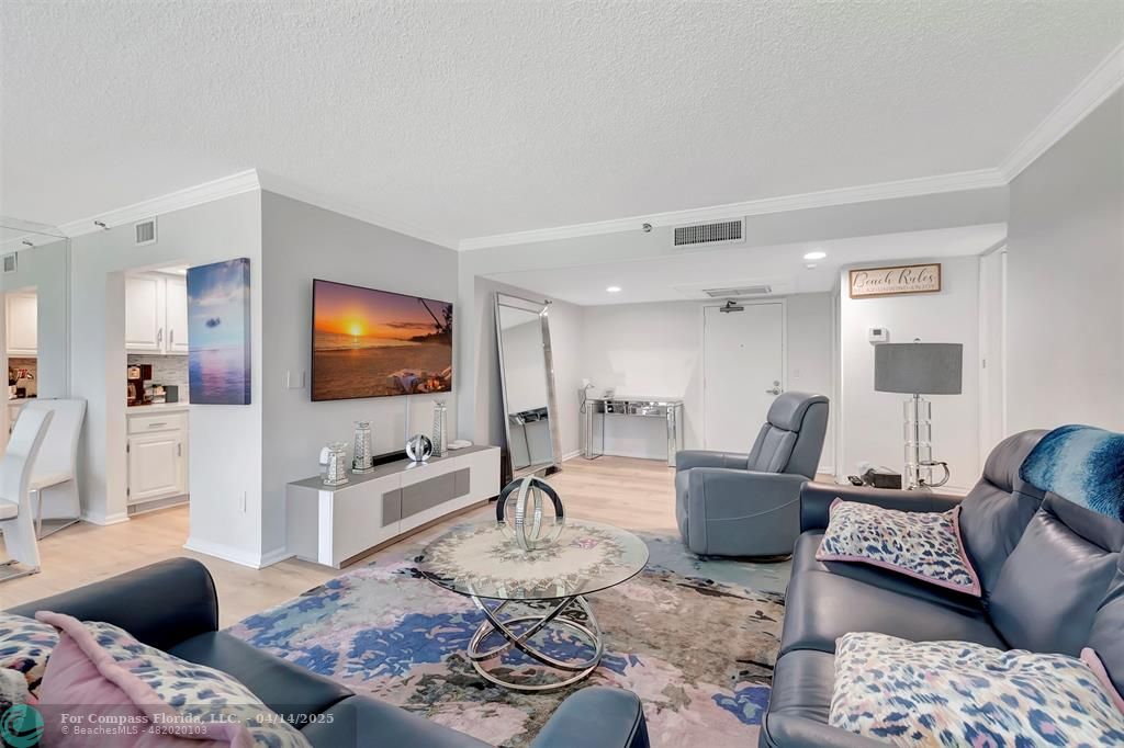 899 Jeffery Street, Unit 109 Boca Raton, FL 33487 - Photo 8 of 37 a living room with furniture and a flat screen tv
