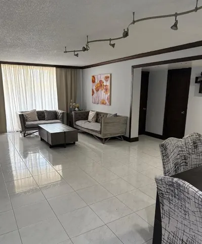 a living room with furniture and a window