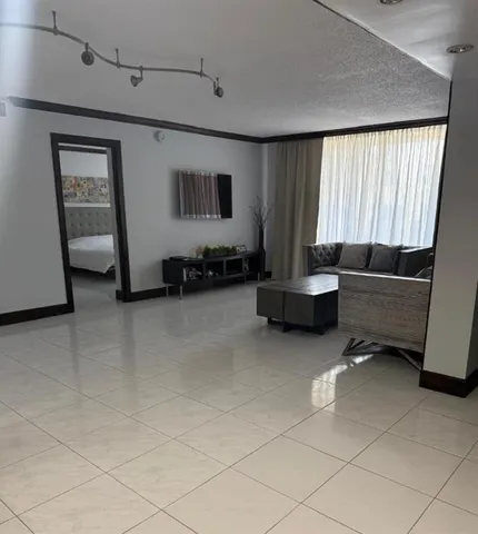 a living room with furniture and a window