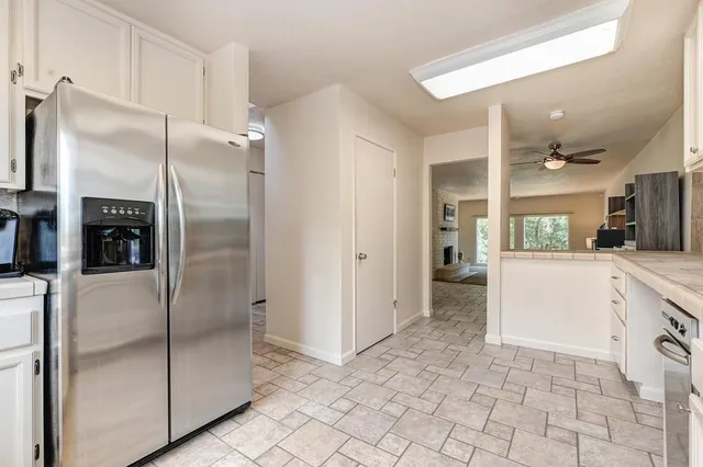 a kitchen with a sink cabinets and a wooden floor