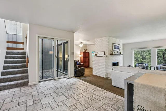 a living room with furniture a large window and a flat screen tv