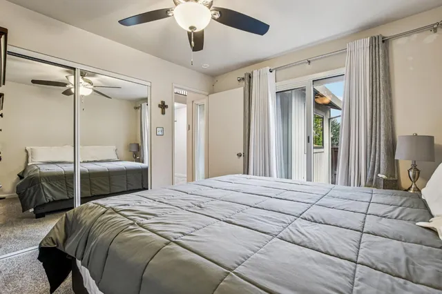 a spacious bedroom with a bed and a large window