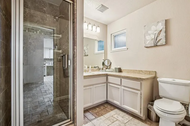 a bed room with a bed mirror and a chandelier