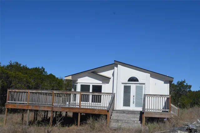 a front view of a house with a wooden fence