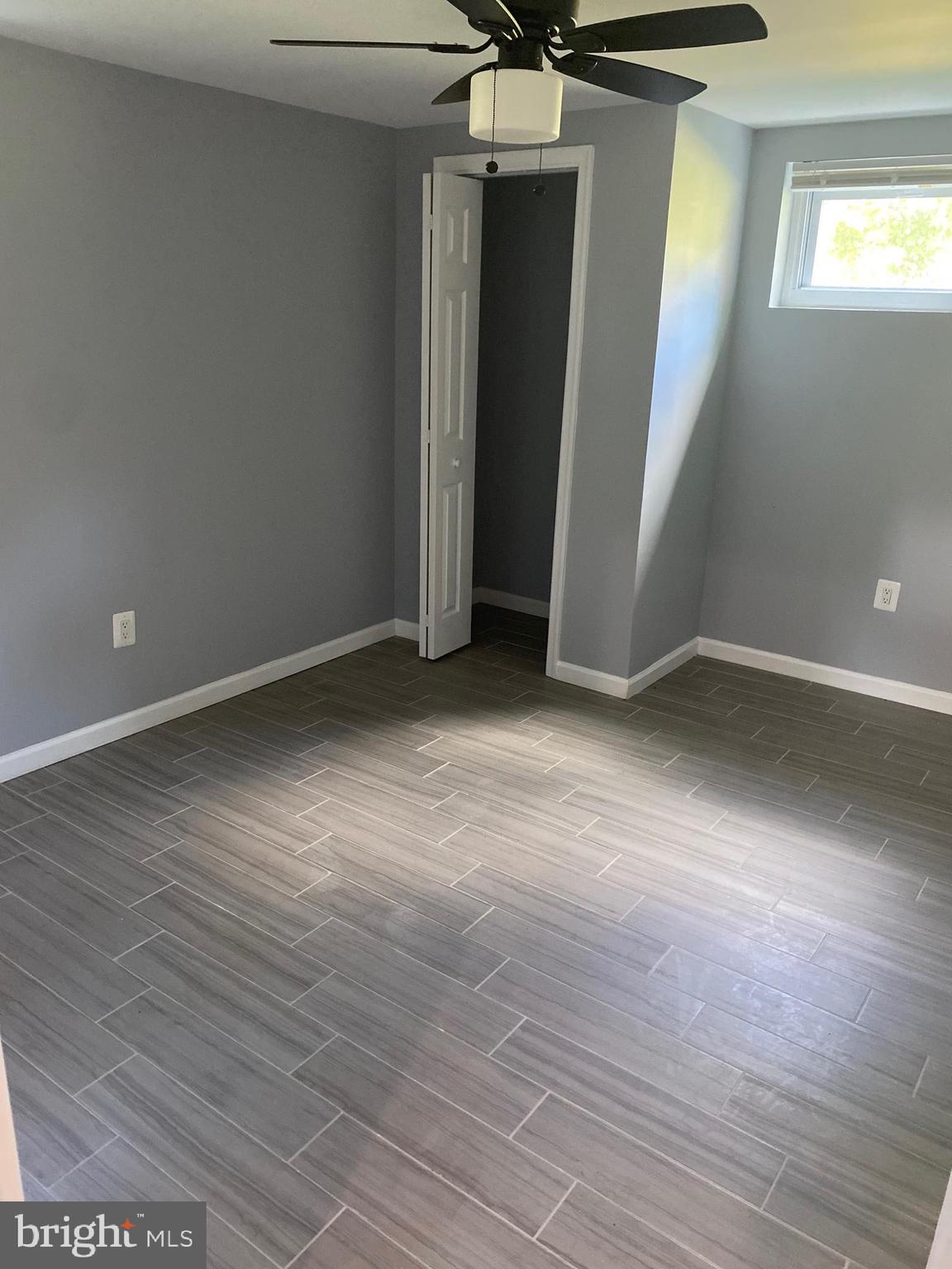 5806 Burgess Road District Heights, MD 20747 - Photo 7 of 11 an empty room with wooden floor and windows