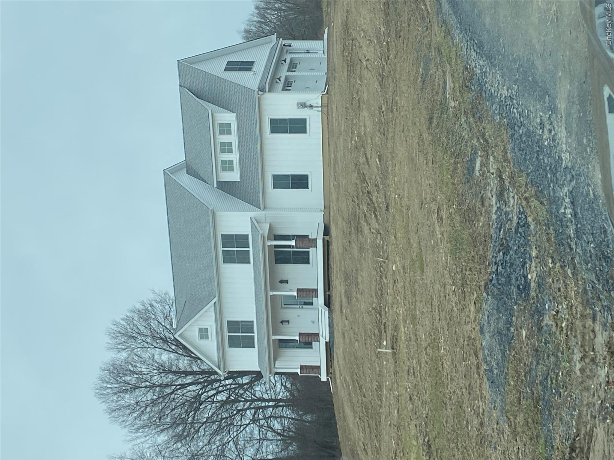a front view of residential houses with yard