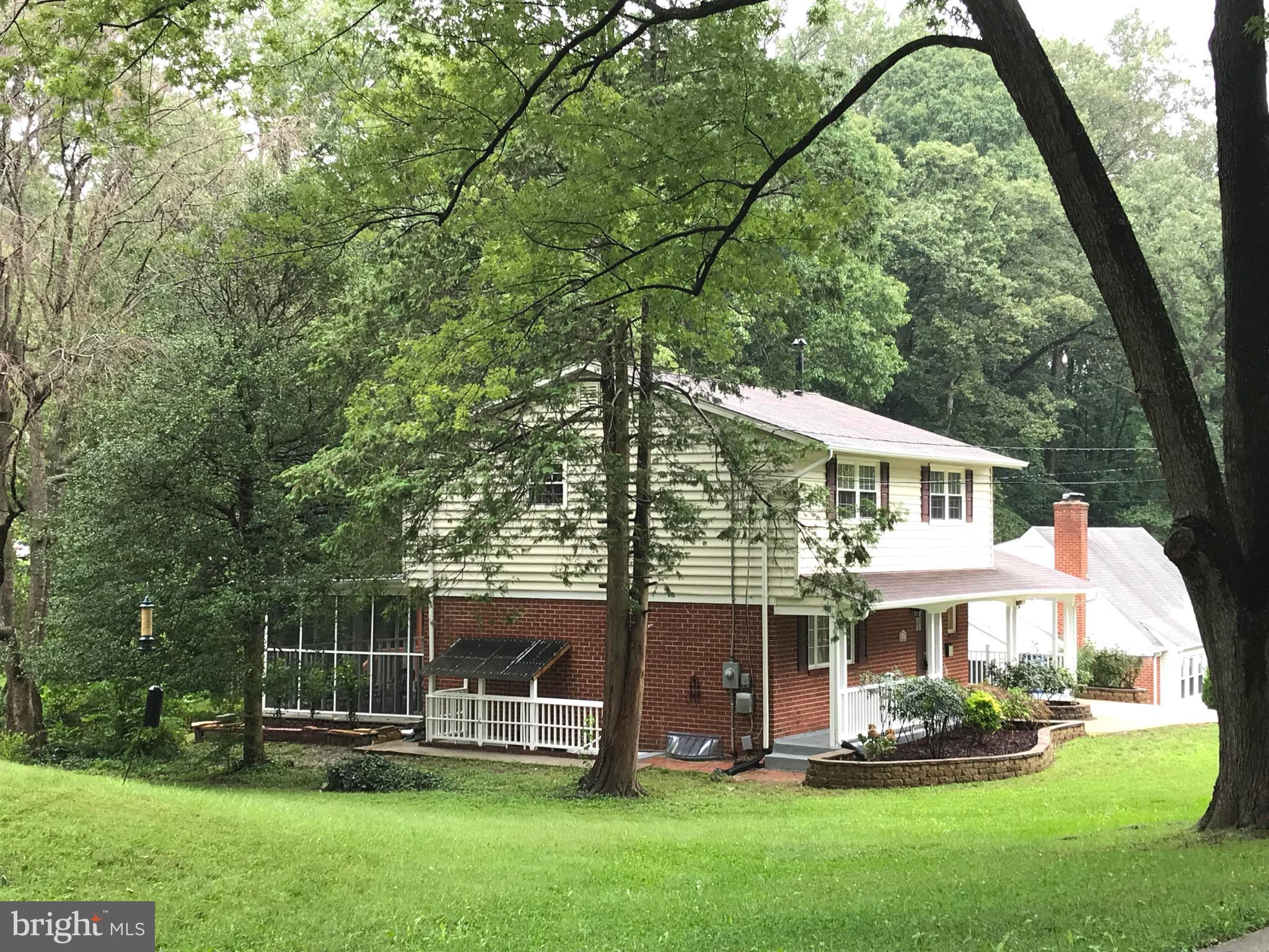 8627 Victoria Road Springfield, VA 22151 - Photo 2 of 30 a front view of a house with a yard table and chairs