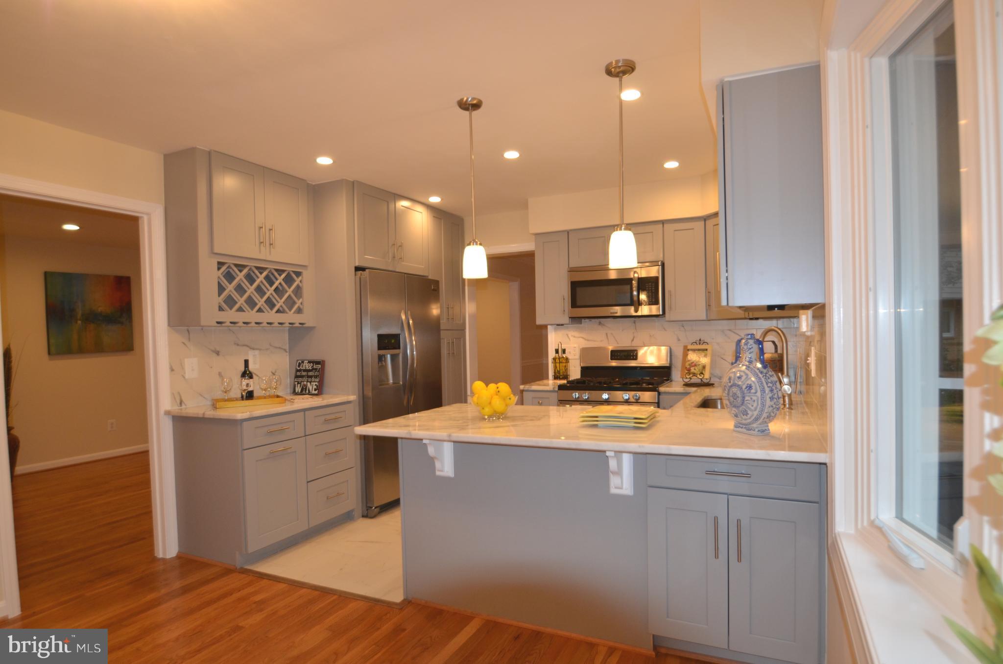 8627 Victoria Road Springfield, VA 22151 - Photo 11 of 30 a kitchen with stainless steel appliances granite countertop a sink a stove and a refrigerator