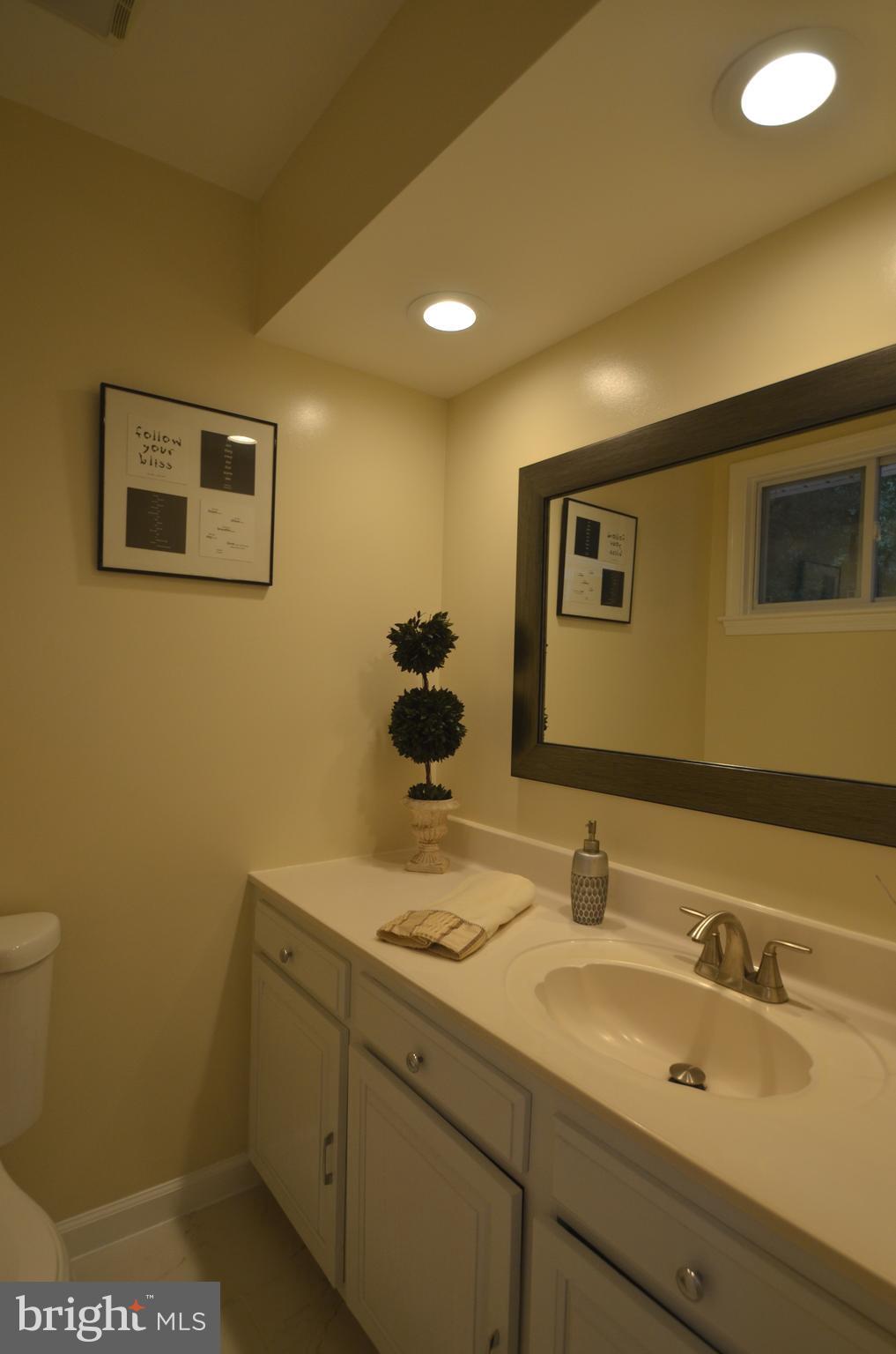 8627 Victoria Road Springfield, VA 22151 - Photo 13 of 30 a bathroom with a sink and a mirror
