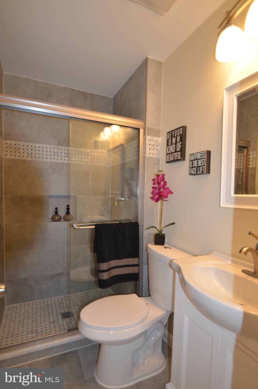 8627 Victoria Road Springfield, VA 22151 - Photo 16 of 30 a bathroom with a sink toilet and shower