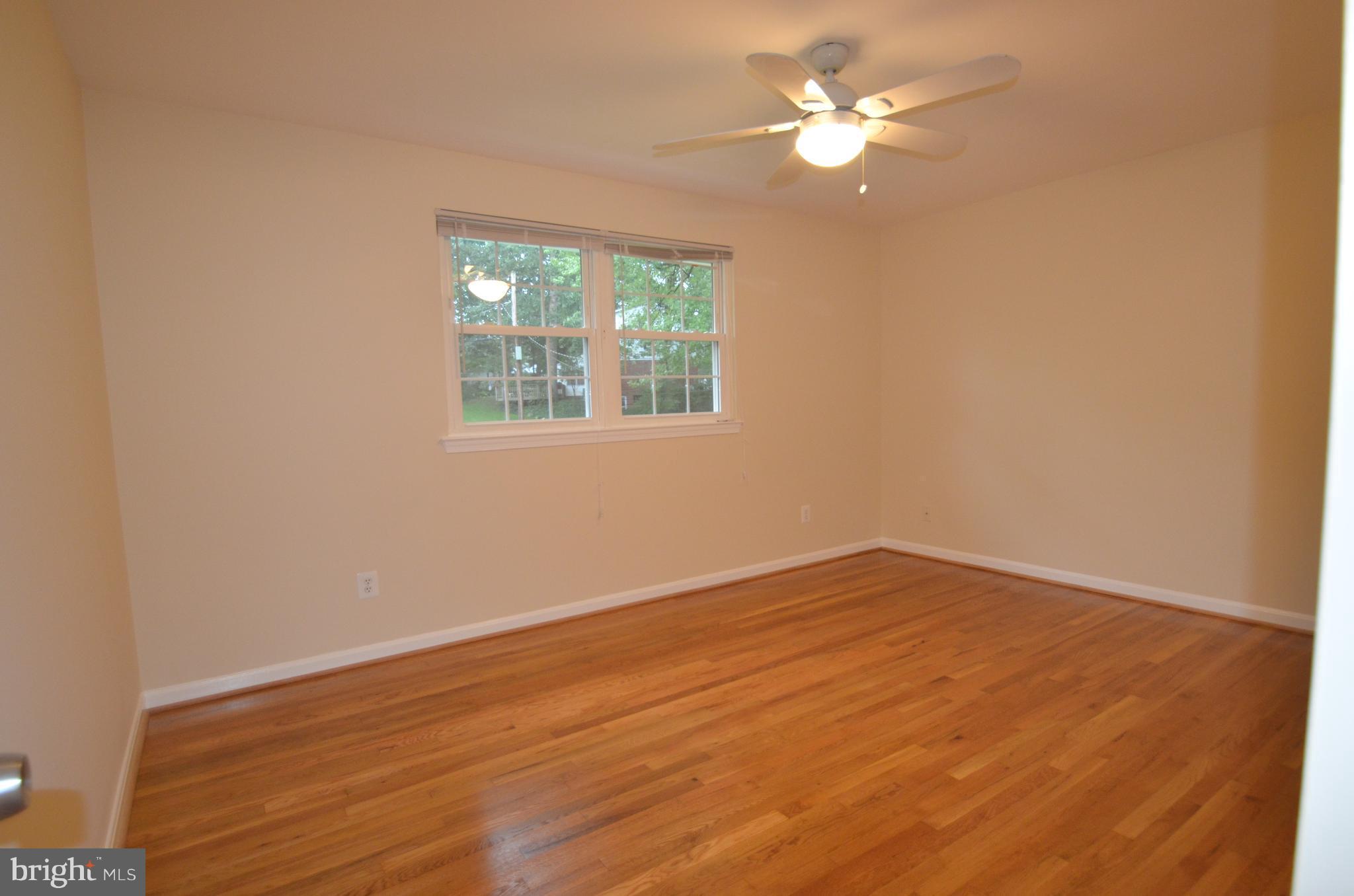8627 Victoria Road Springfield, VA 22151 - Photo 17 of 30 wooden floor in an empty room with a window