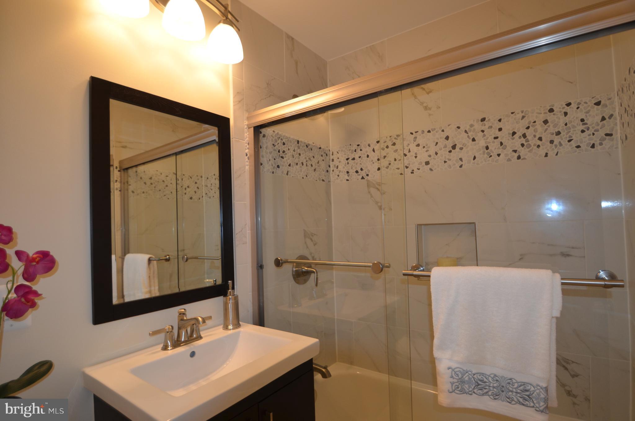 8627 Victoria Road Springfield, VA 22151 - Photo 20 of 30 a bathroom with a sink and a mirror