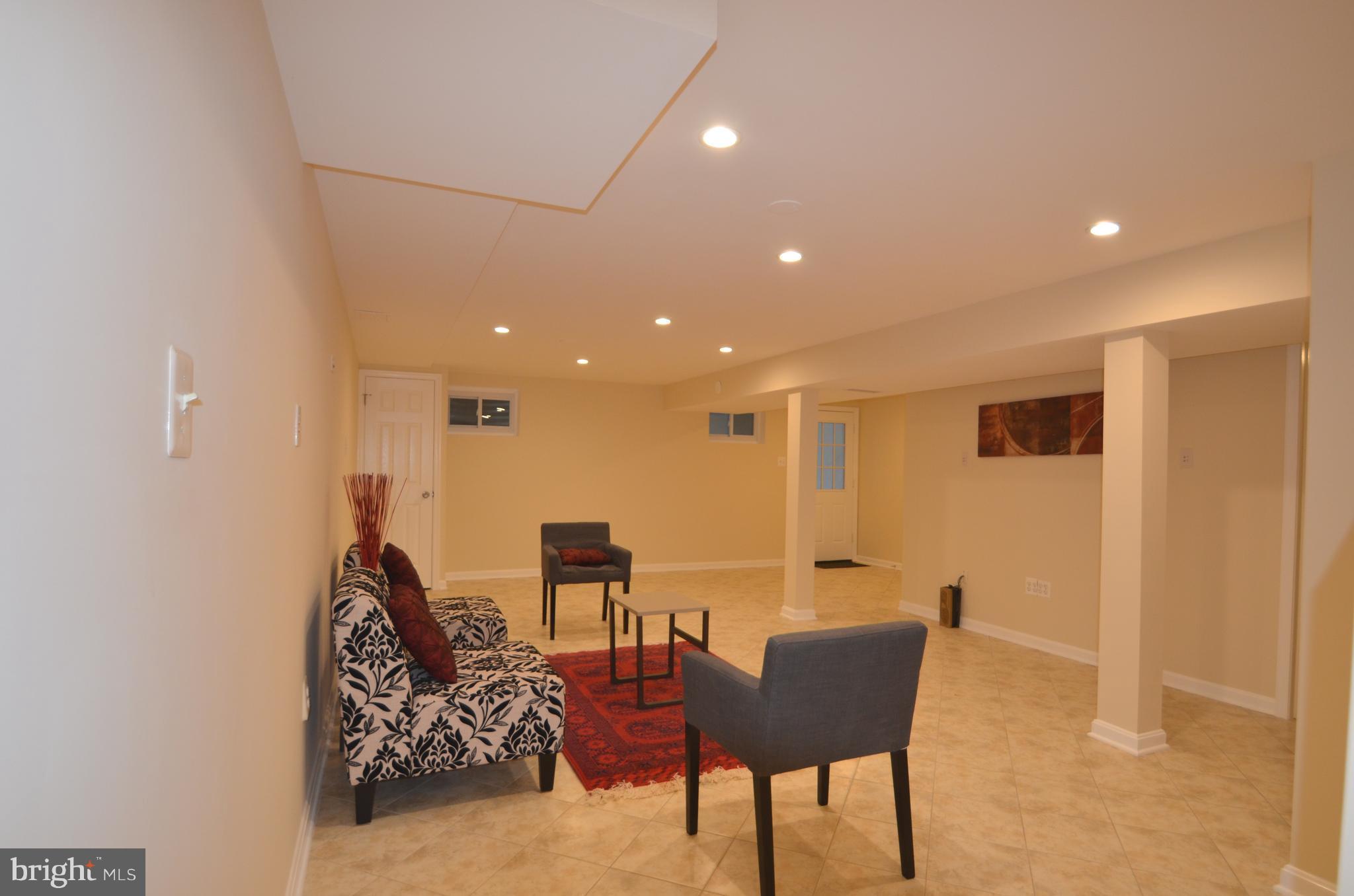 8627 Victoria Road Springfield, VA 22151 - Photo 22 of 30 a living room with furniture and a wooden floor
