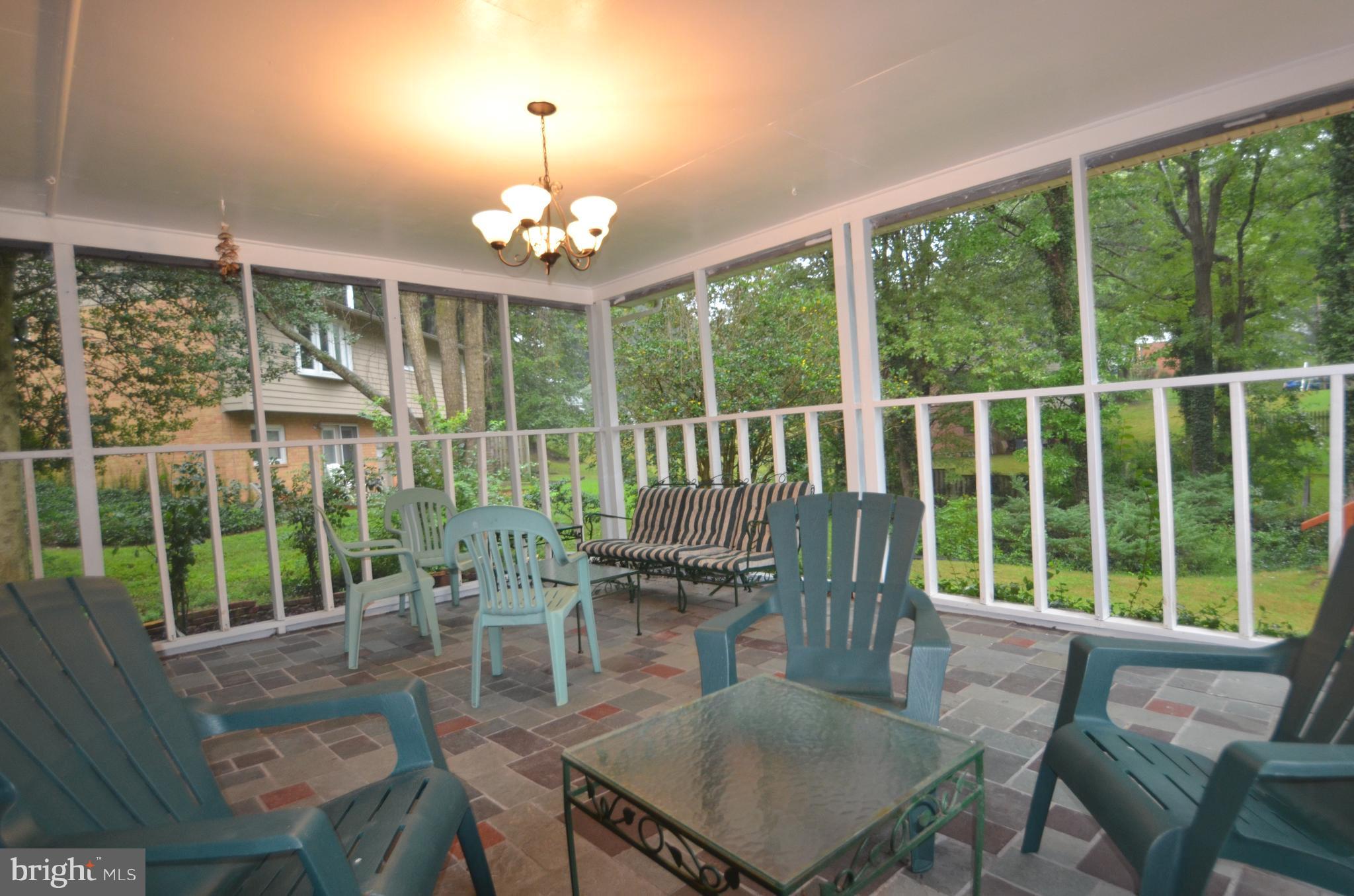8627 Victoria Road Springfield, VA 22151 - Photo 25 of 30 a view of a dining room with furniture large windows and wooden floor