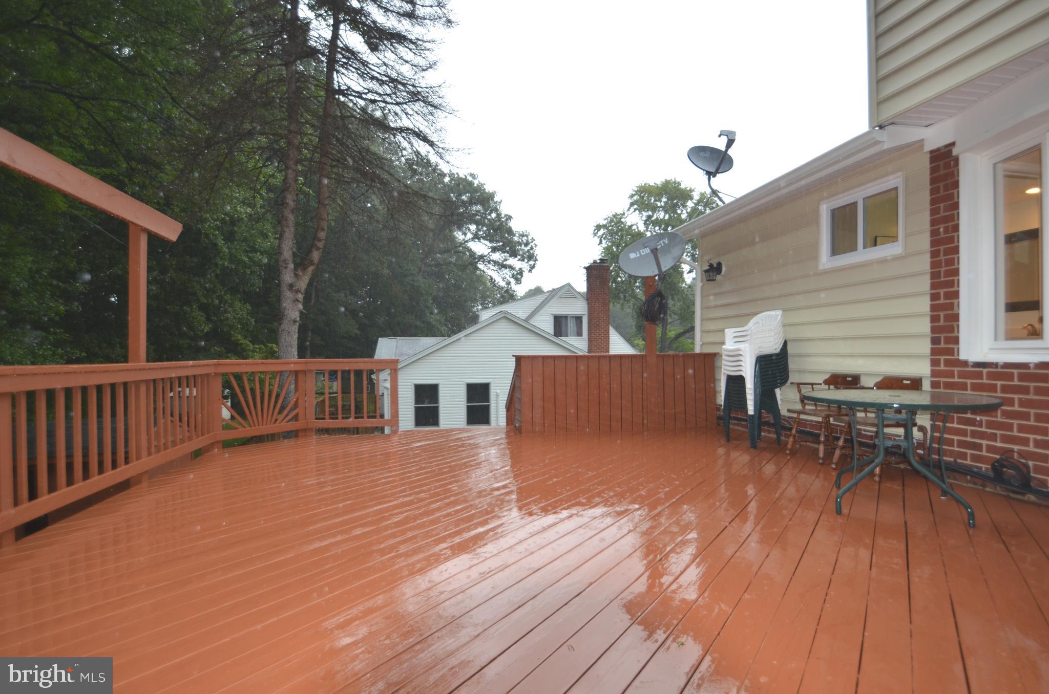 8627 Victoria Road Springfield, VA 22151 - Photo 27 of 30 a view of a house with wooden deck and furniture