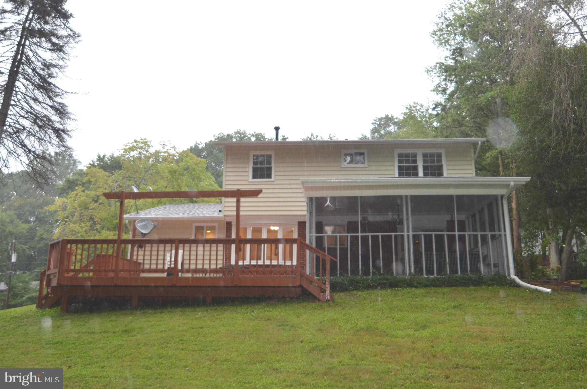 8627 Victoria Road Springfield, VA 22151 - Photo 29 of 30 a view of a house with a deck and a yard