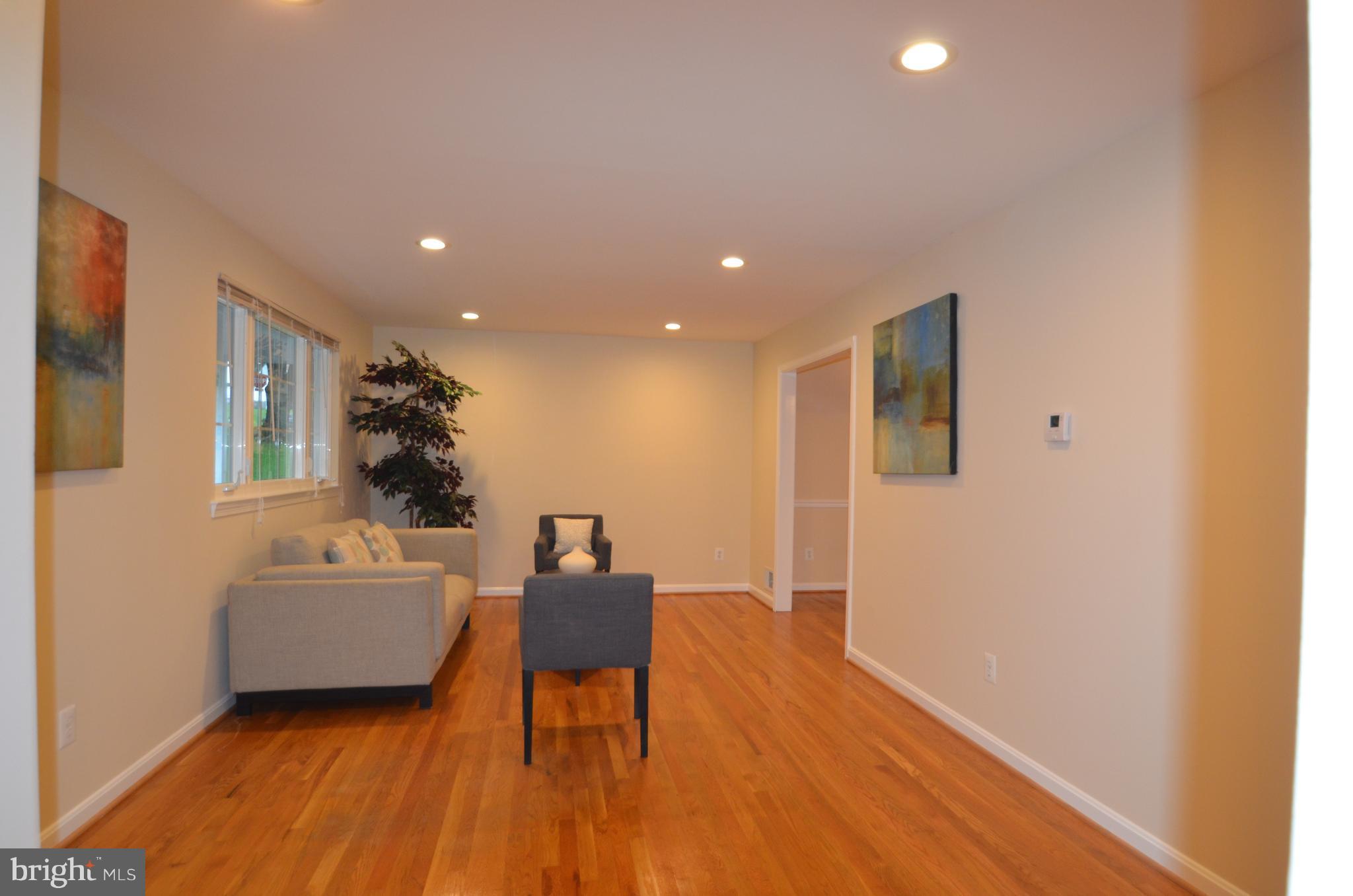 8627 Victoria Road Springfield, VA 22151 - Photo 5 of 30 a living room with furniture and a wooden floor