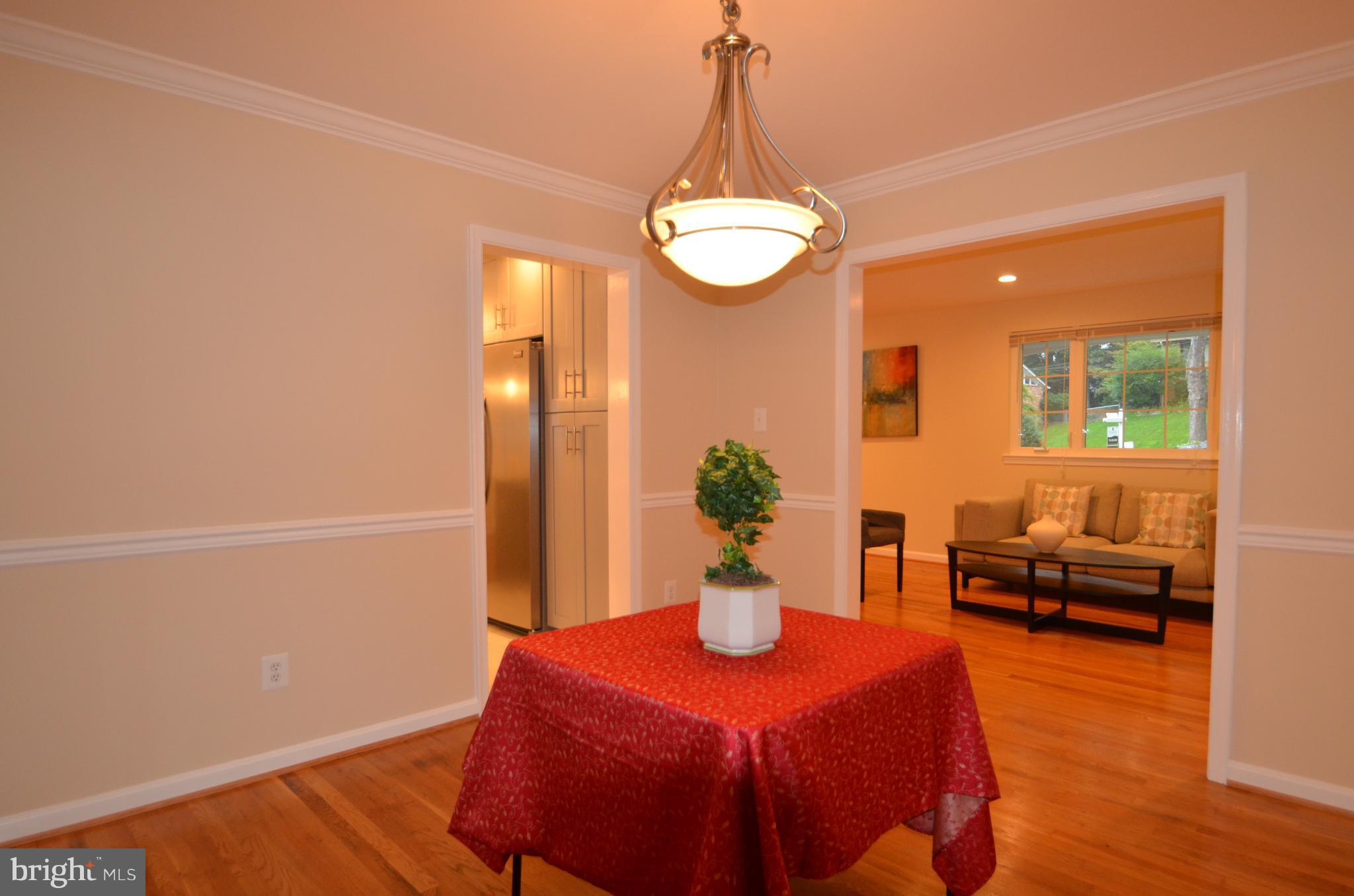 8627 Victoria Road Springfield, VA 22151 - Photo 7 of 30 a view of a dining room with furniture and wooden floor