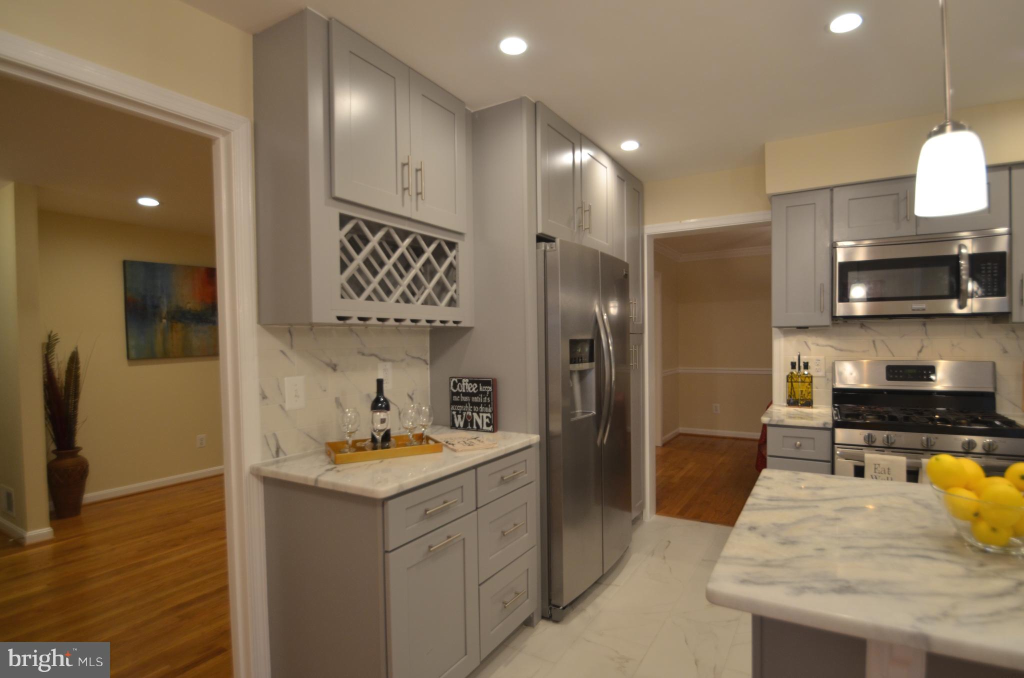 8627 Victoria Road Springfield, VA 22151 - Photo 9 of 30 a kitchen with stainless steel appliances a sink stove and refrigerator
