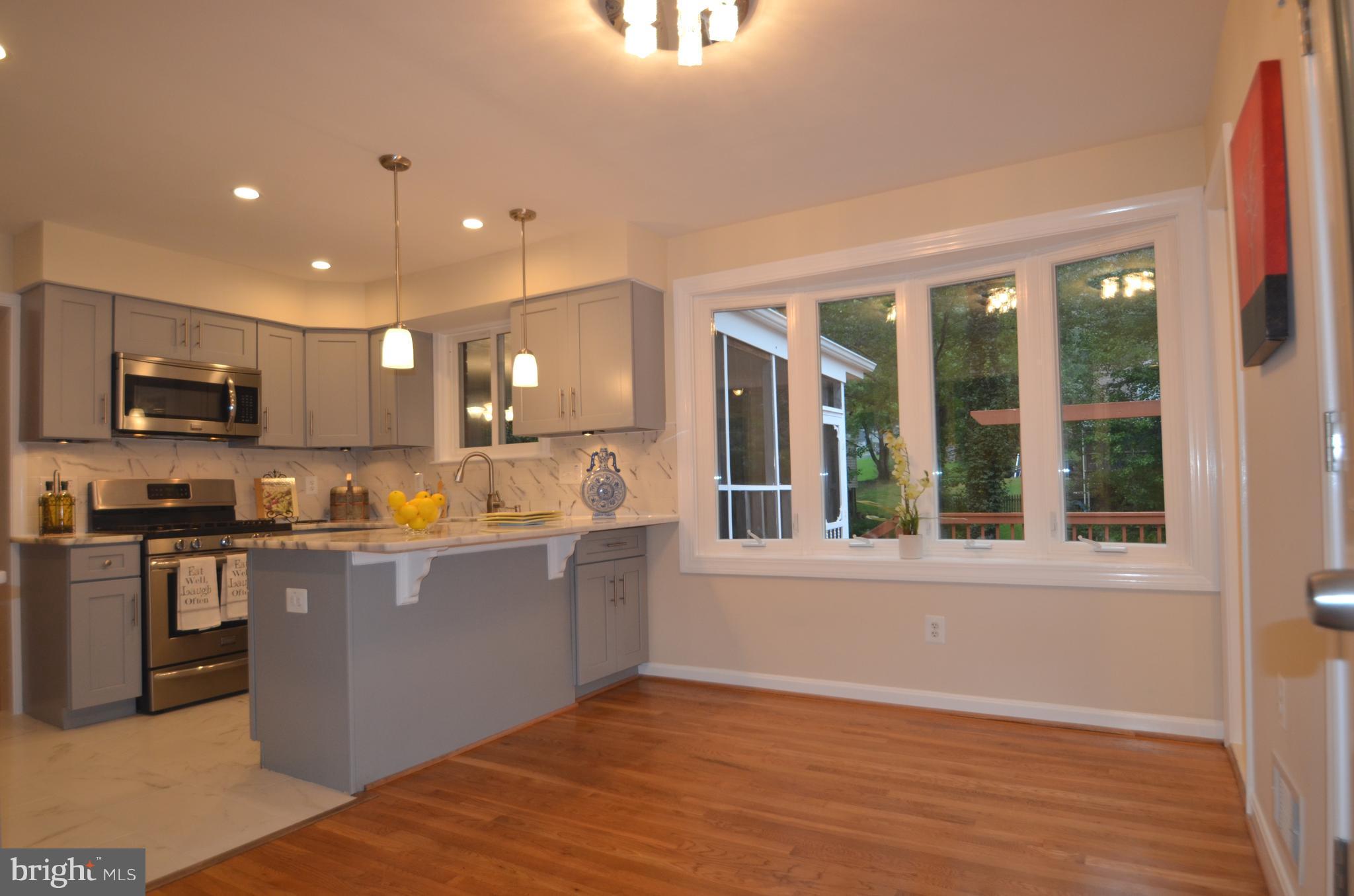 8627 Victoria Road Springfield, VA 22151 - Photo 10 of 30 a kitchen with stainless steel appliances granite countertop a stove and a sink