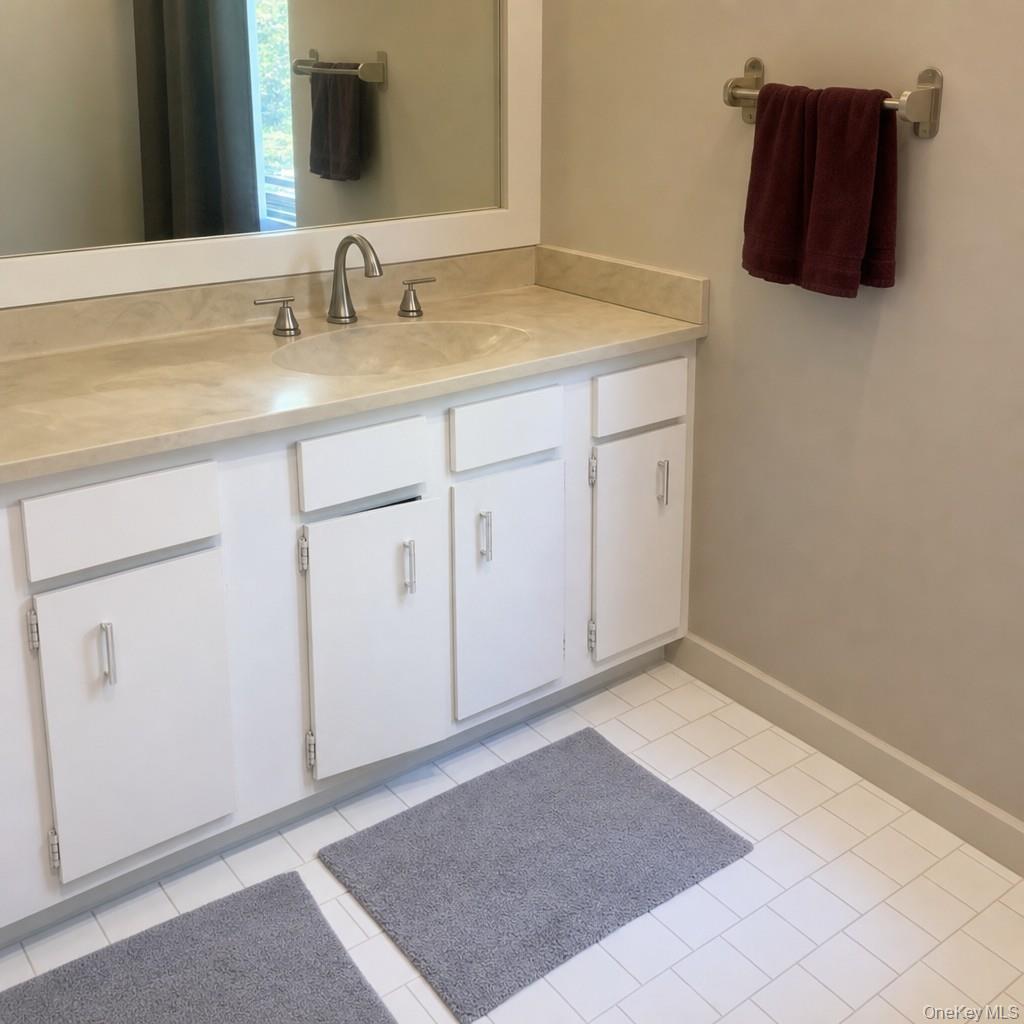 719 North Sea Road Southampton, NY 11968 - Photo 6 of 6 a bathroom with a sink and a mirror