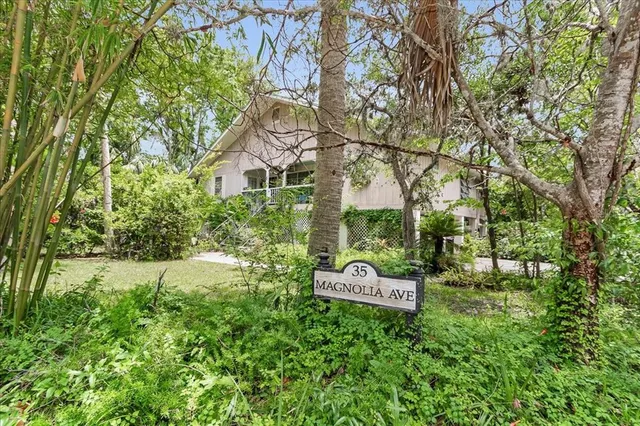 an aerial view of a house with a yard and lake view