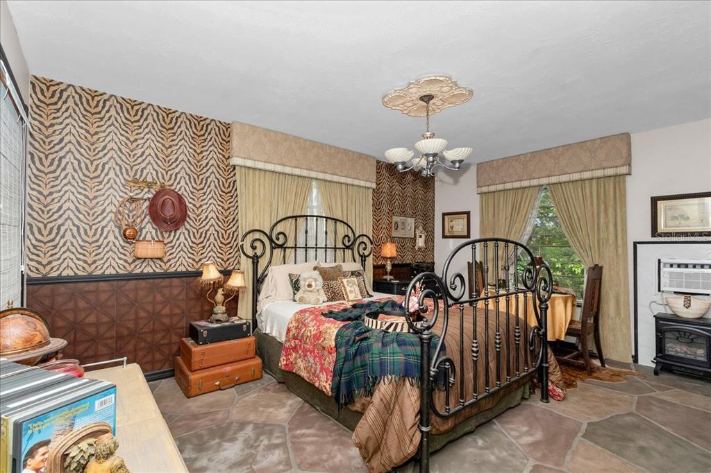 35 Magnolia Avenue Yankeetown, FL 34498 - Photo 26 of 75 a bedroom with a bed and a chandelier