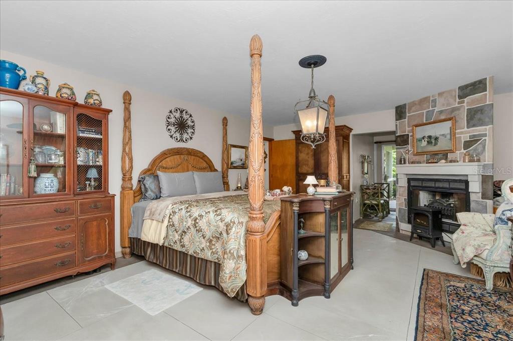 35 Magnolia Avenue Yankeetown, FL 34498 - Photo 32 of 75 a bedroom with a bed and a fireplace