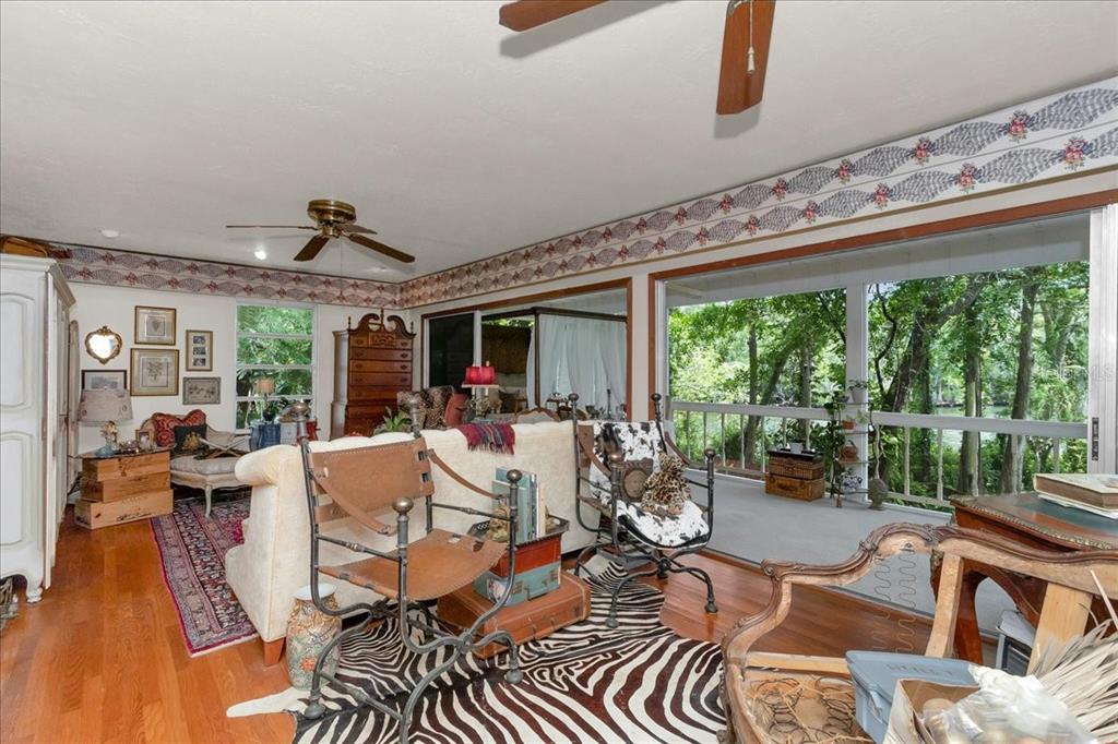 35 Magnolia Avenue Yankeetown, FL 34498 - Photo 40 of 75 a living room with patio furniture and a floor to ceiling window