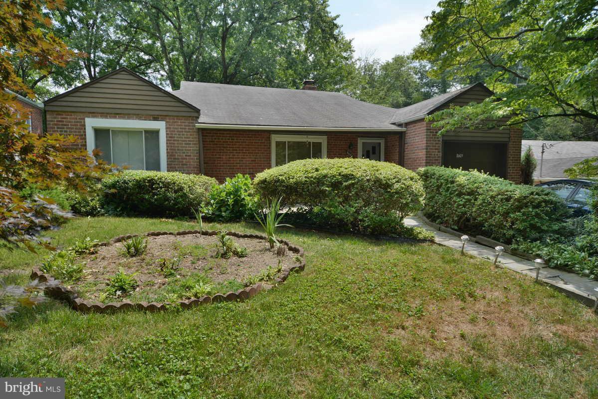 8605 Springdell Place Chevy Chase, MD 20815 - Photo 2 of 15 a front view of a house with a garden